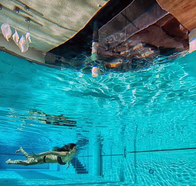 Frau taucht im Indoorpool